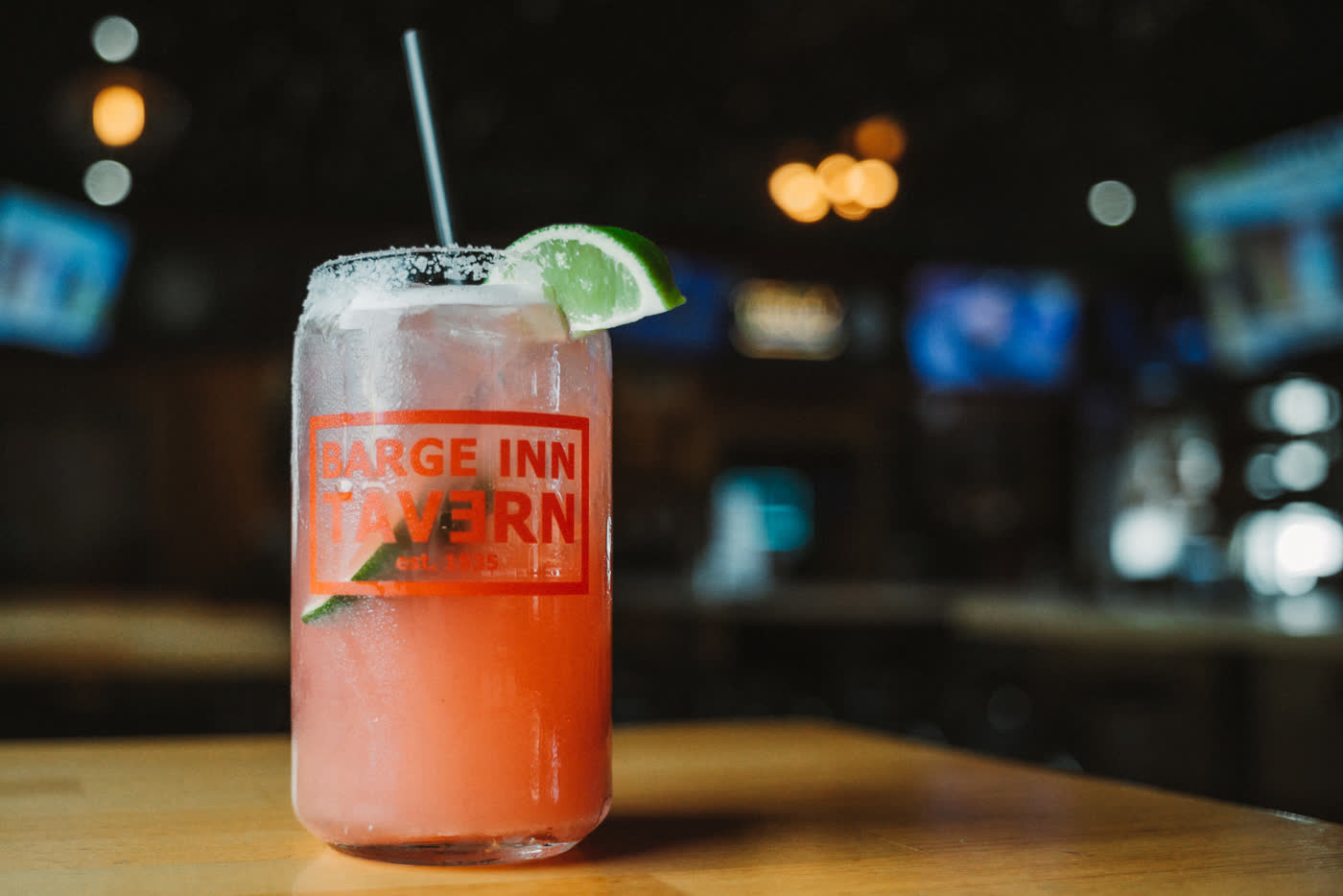 Raspberry margarita with a salted rim and lime wedge in a Barge Inn Tavern glass at the bar in Newport, Oregon