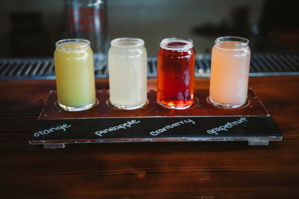 Mimosa flight with orange, pineapple, cranberry, and grapefruit at Barge Inn Tavern bar