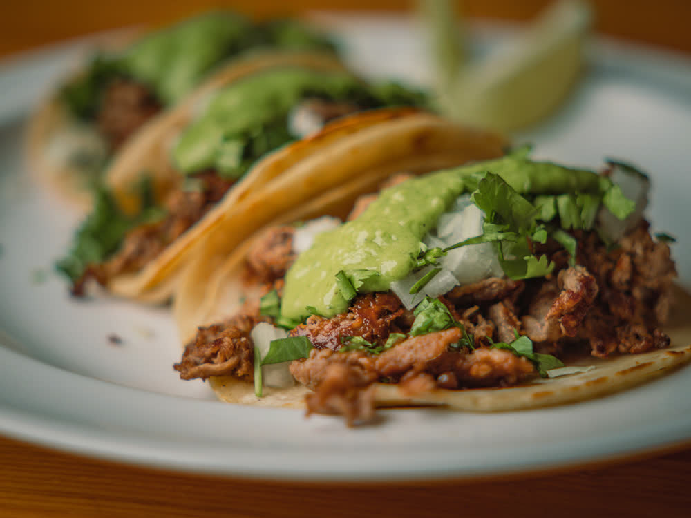 Street tacos with cilantro and salsa verde at Barge Inn Tavern, Newport's bayfront dive bar