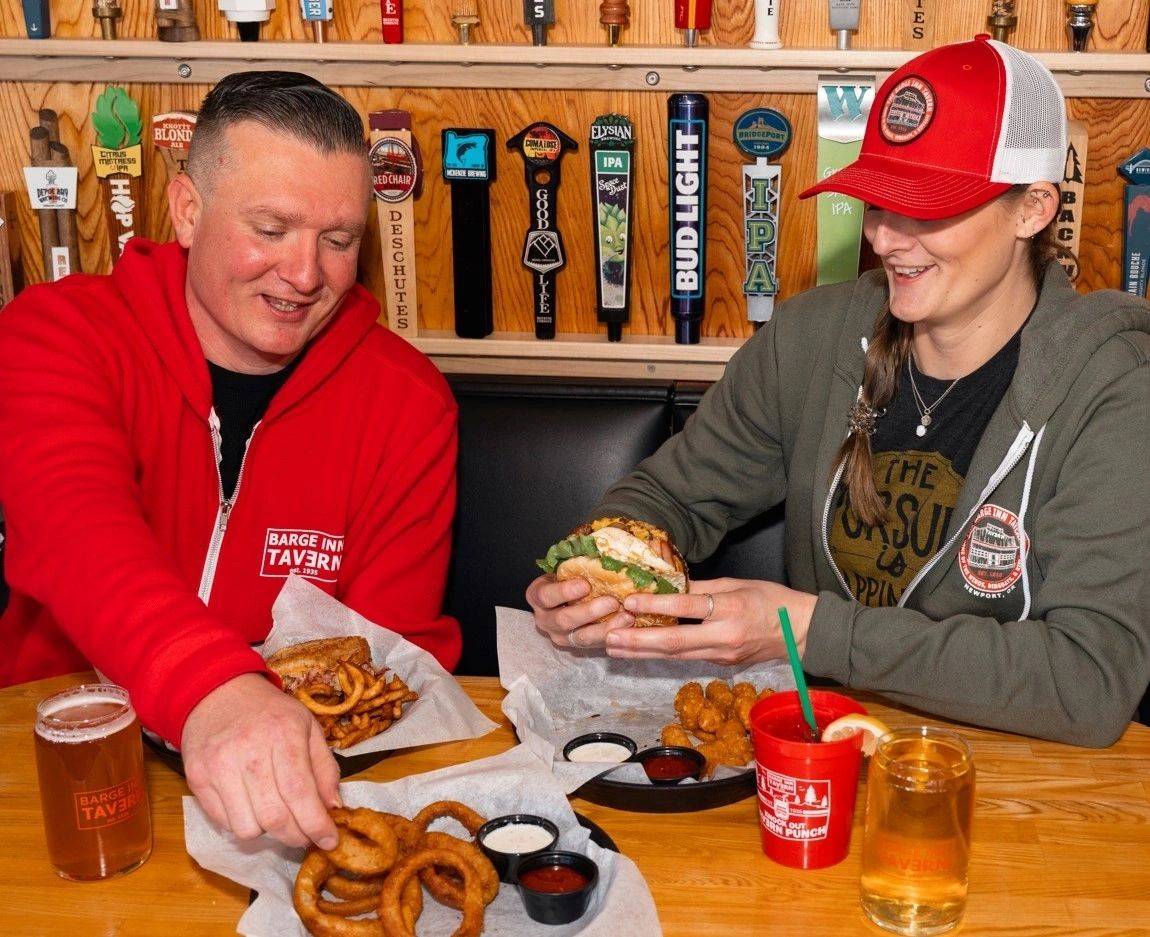 Couple sharing a Barge Cheeseburger in Newport Oregon