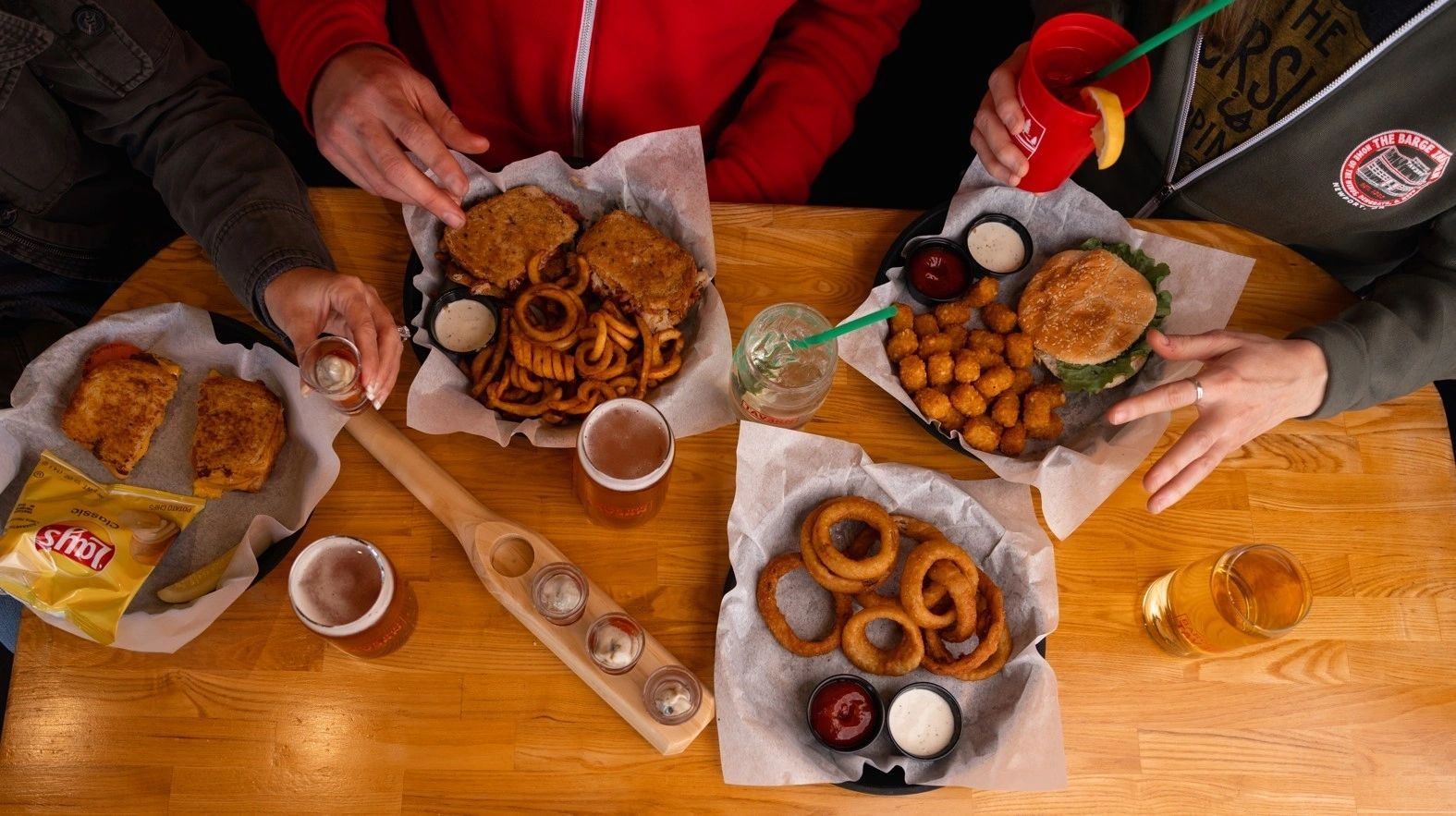 Burgers, onion rings, and beer spread at Barge Inn Tavern Newport Oregon
